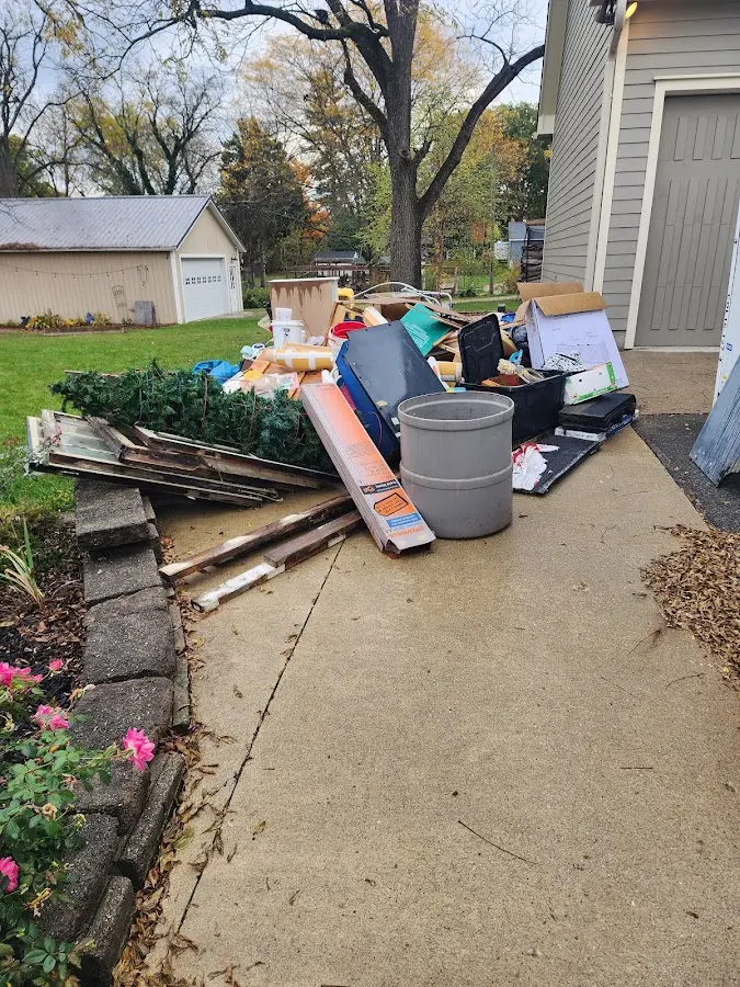 Dumpster being loaded with debris for 30 Yard Dumpster Rental in Southold